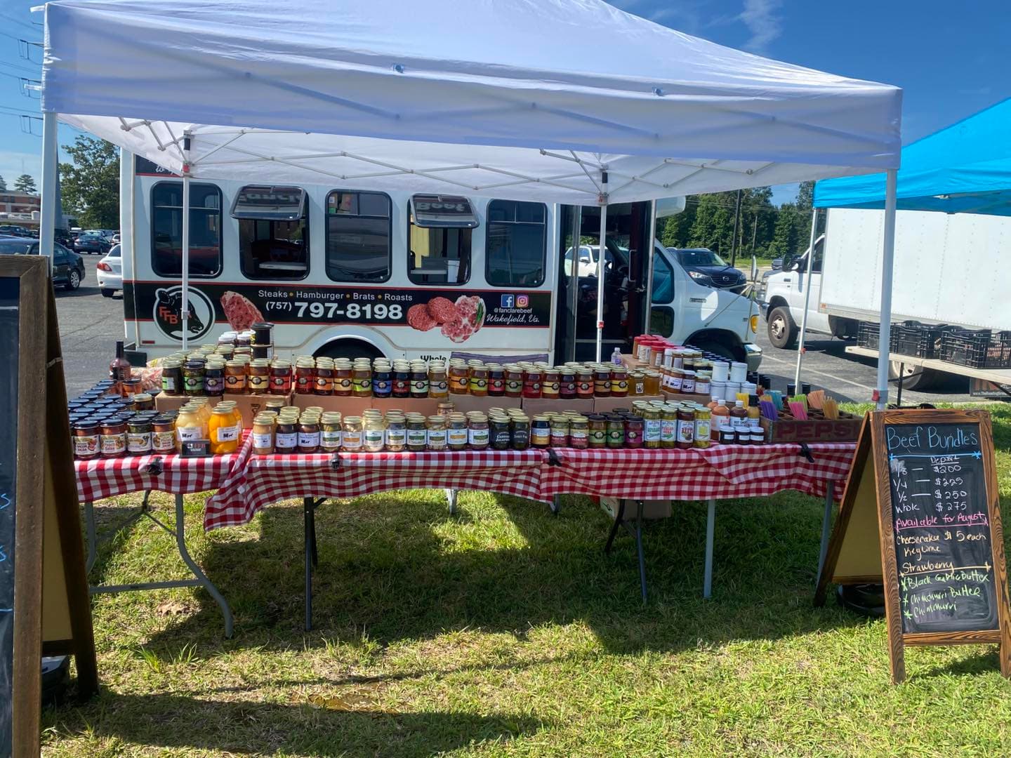 Fanclare Farms market booth with fresh beef and pork cuts